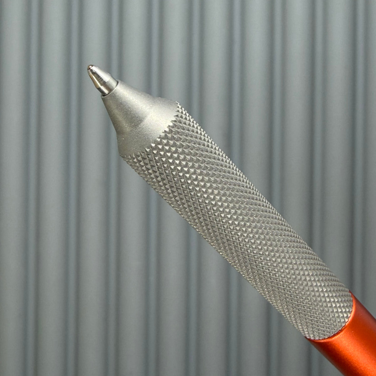 > Spoke Click Model C: Orange Lava Aluminum / Matte Titanium Peak Knurled Grip