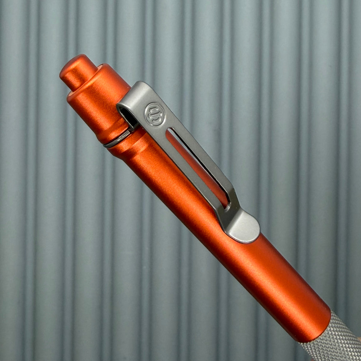 > Spoke Click Model C: Orange Lava Aluminum / Matte Titanium Peak Knurled Grip