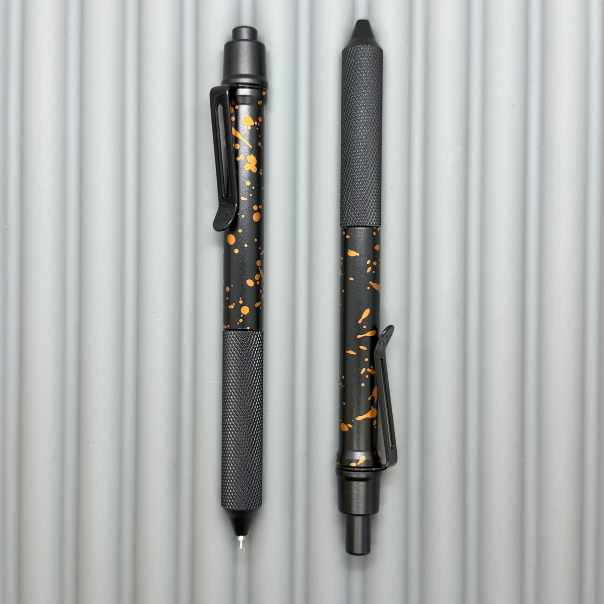 > Spoke Click Model C: Black with Orange Lava Splash, Aluminum / Black Aluminum Peak Knurled Grip