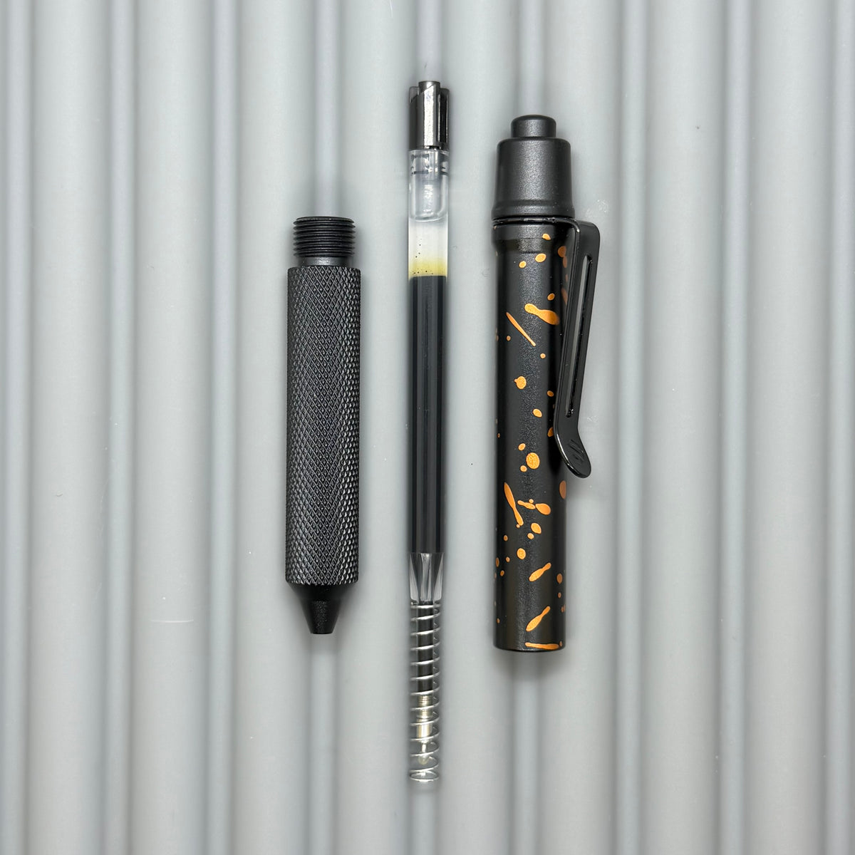 > Spoke Click Model C: Black with Orange Lava Splash, Aluminum / Black Aluminum Peak Knurled Grip