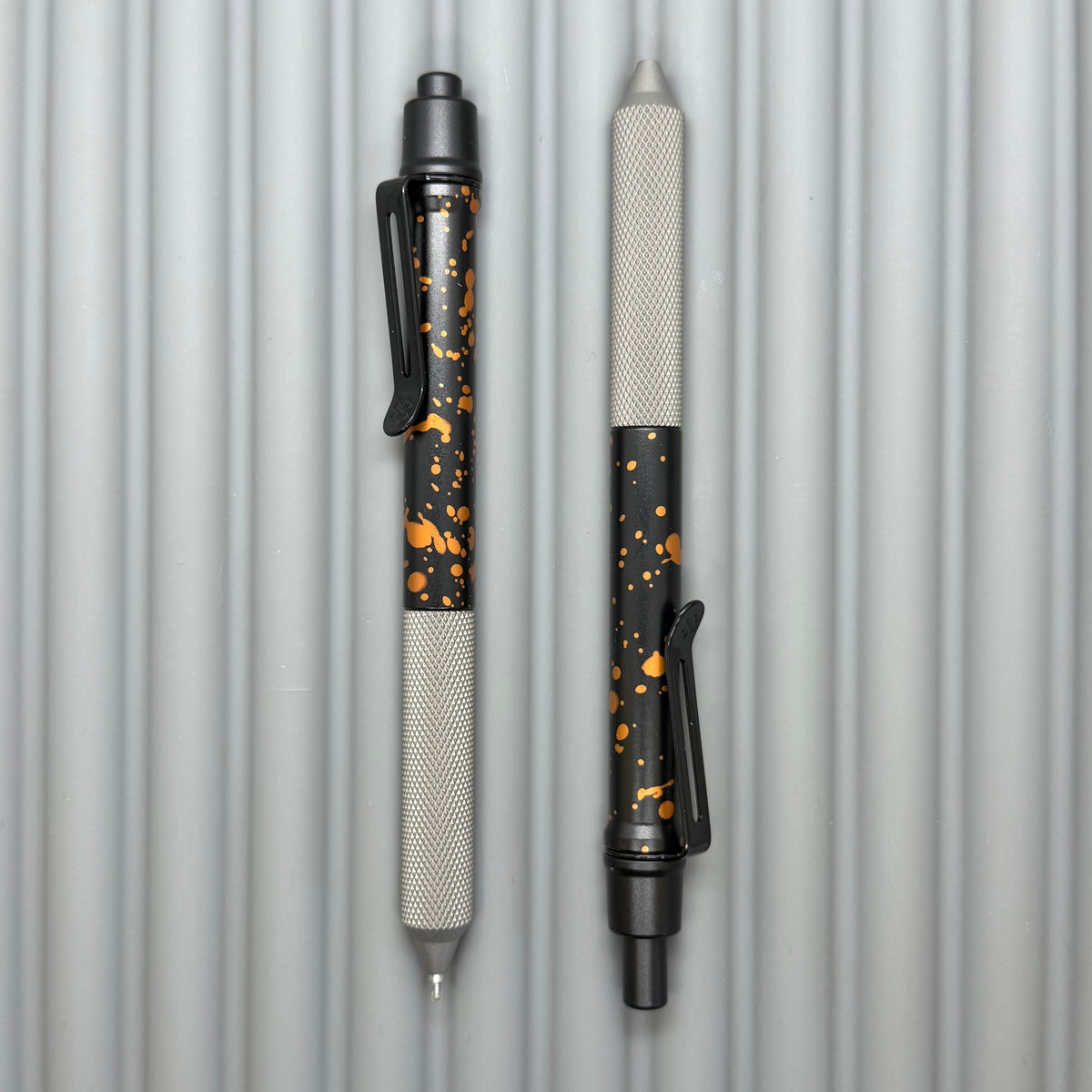 > Spoke Click Model C: Black with Orange Lava Splash, Aluminum / Matte Titanium Peak Knurled Grip