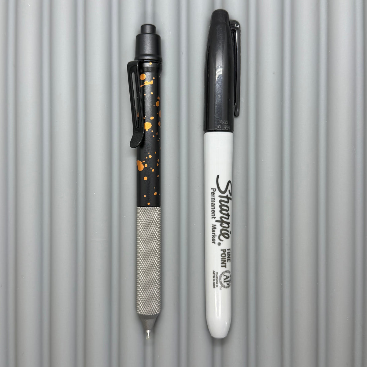> Spoke Click Model C: Black with Orange Lava Splash, Aluminum / Matte Titanium Peak Knurled Grip