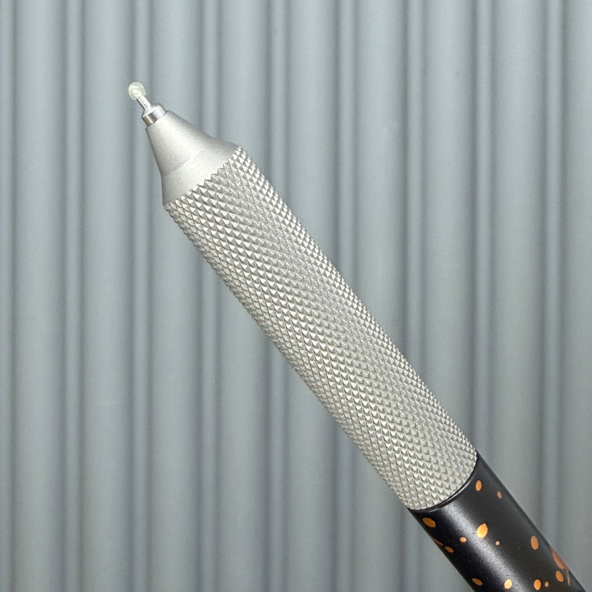 > Spoke Click Model C: Black with Orange Lava Splash, Aluminum / Matte Titanium Peak Knurled Grip