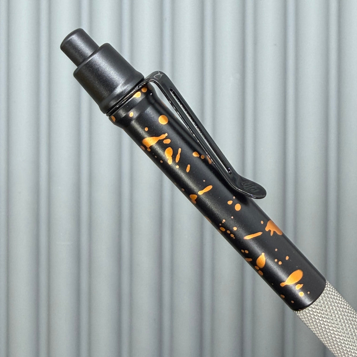 > Spoke Click Model C: Black with Orange Lava Splash, Aluminum / Matte Titanium Peak Knurled Grip